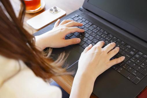 Hands of a woman working on a laptop, JPG