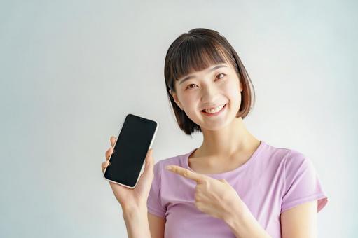 A woman holding a smartphone in sportswear, akıllı telefon, uygunluk, kadın, JPG