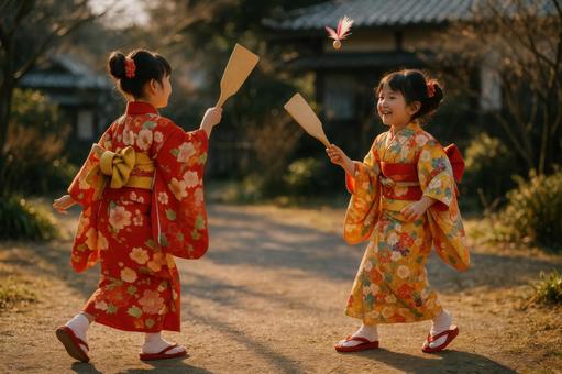 羽子板遊びを楽しむ子供たち 羽子板遊びを楽しむ子供たちの写真