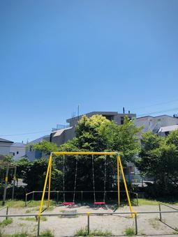 Colorful swings in a summer park, JPG