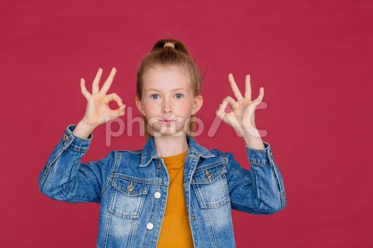 カメラ目線でオッケーマークのジェスチャーをするジージャンの女の子 女の子,オッケーマーク,ジェスチャーの写真素材