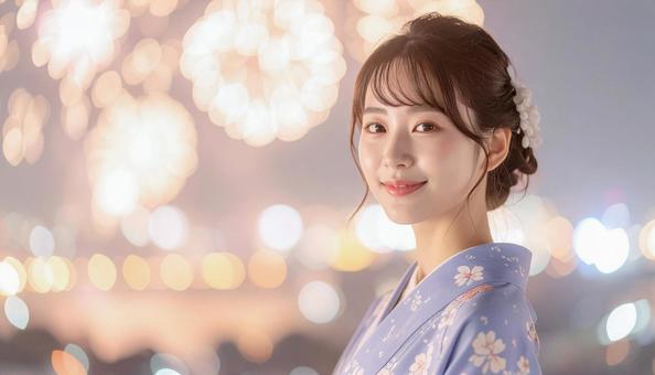 浴衣の女性と夜空と花火の写真