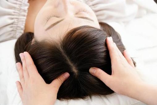 Hands of women and practitioners receiving scalp massage Hands of women and practitioners receiving scalp massage