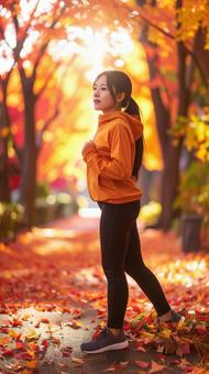 紅葉の中 スポーツウェアを着た女性 紅葉の中 スポーツウェアを着た女性の写真