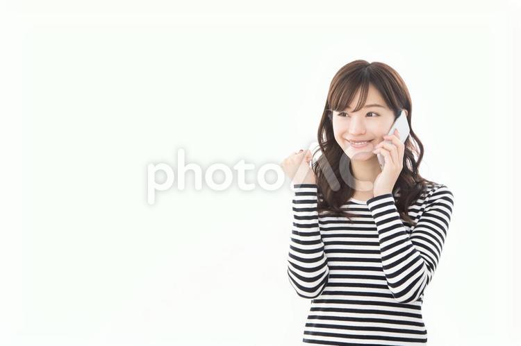 若い女性　スマートフォン　ガッツポーズ スマートフォン,ガッツポーズ,話すの写真素材