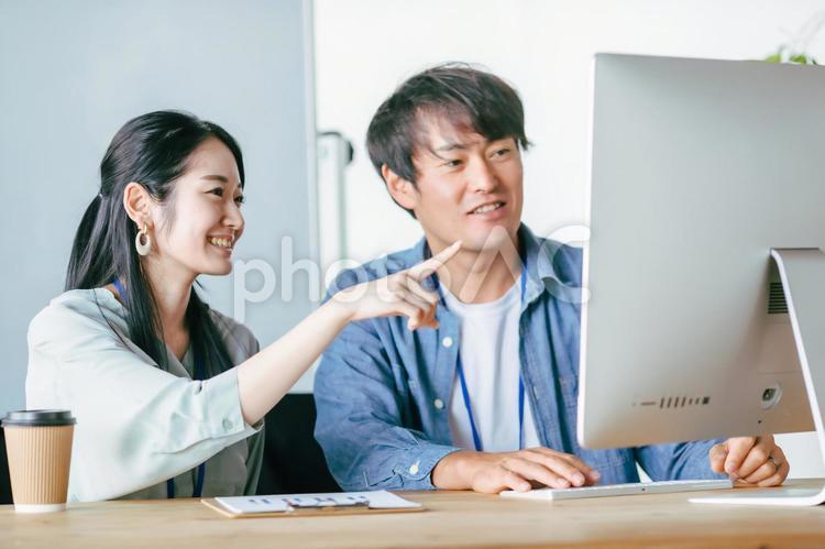 オフィスでミーティングする男女の会社員 クリエイター,エンジニア,デザイナーの写真素材