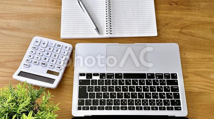 デスクの上のノートとパソコン デスクワーク,ノートパソコン,ビジネスの写真素材