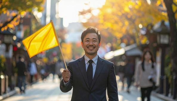 旗を持って旅行客を導く男性の旅行添乗員 旗を持って旅行客を導く男性の旅行添乗員の写真