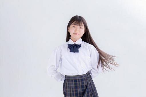 制服を着たロングヘアの小学生 制服,白背景,カメラ目線の写真素材