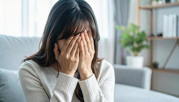 顔を両手で覆って泣く日本人女性 顔を両手で覆って泣く日本人女性の写真