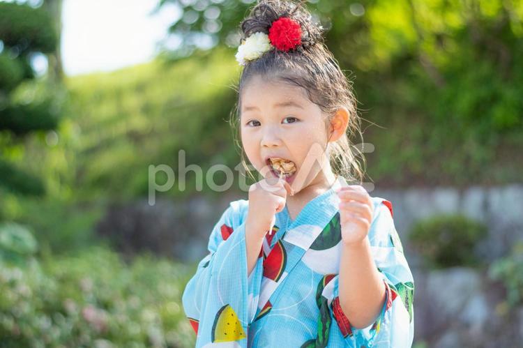 唐揚げを食べる女の子 子供,浴衣,女の子の写真素材