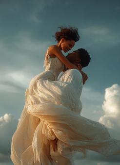 青空の下で抱き合う新郎新婦の写真