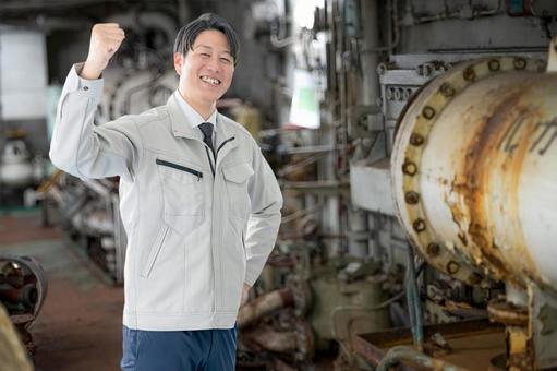 ガッツポーズする作業員 ガッツポーズする作業員 作業員,男性,作業服の写真素材