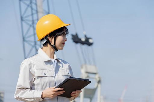 Woman in work clothes at a construction site, JPG