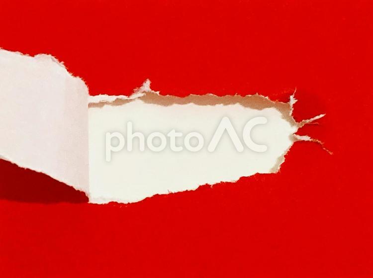 赤い折り紙をめくる・破く 穴,破ける,破るの写真素材