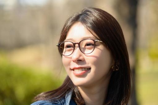 公園で微笑むメガネの女性 公園で微笑むメガネの女性 メガネ,眼鏡,人物の写真素材