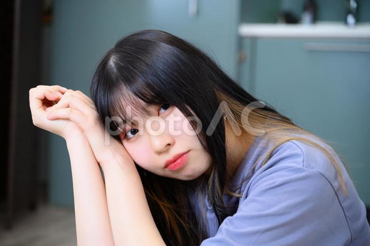 少し不満そうにこちらを見る10代の女性 女性,女子,女の写真素材