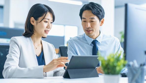 タブレットで打ち合わせするビジネス社員 タブレットで打ち合わせするビジネス社員の写真