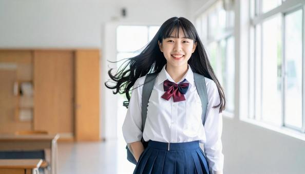 通学で風に髪が揺れる女子高校生 通学で風に髪が揺れる女子高校生の写真