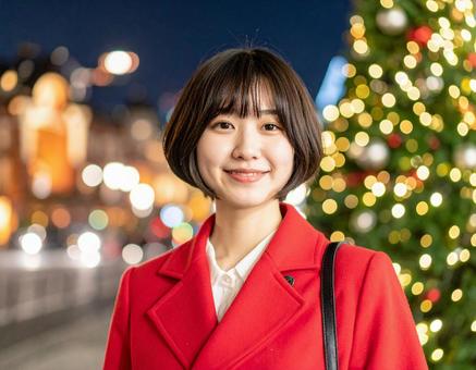 クリスマスツリーと赤いコートの彼女の写真