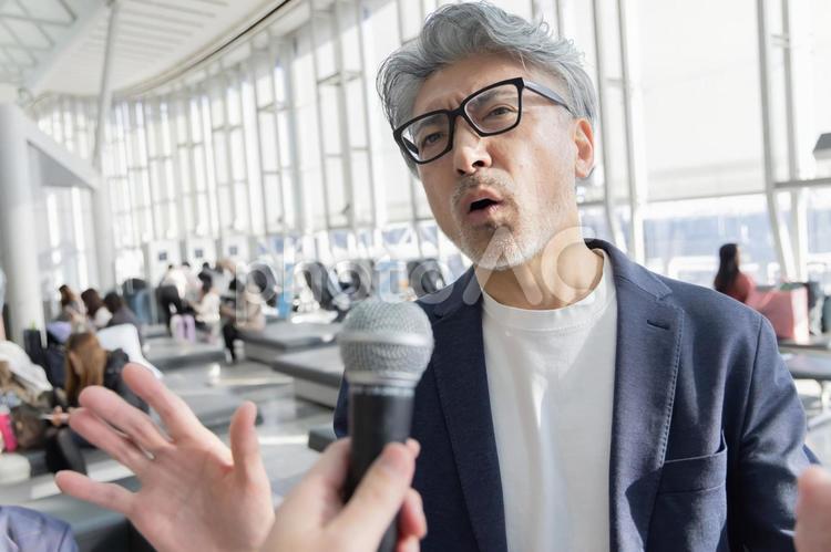 ミドル男性　空港　旅行　インタビュー 空港,ミドル,ビジネスの写真素材