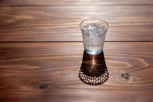 Glass of water on a wood table, JPG