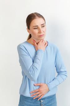 喉とお腹を押さえる女性 生理,月経,女性の写真素材