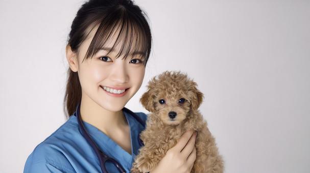 子犬を抱き優しく微笑む女性獣医師 子犬を抱き優しく微笑む女性獣医師の写真