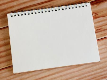 A notebook placed on a wooden desk, JPG A notebook placed on a wooden desk, JPG