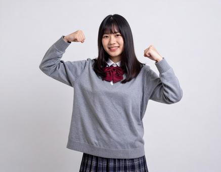 ガッツポーズをする女子生徒のイメージ ガッツポーズをする女子生徒のイメージの写真