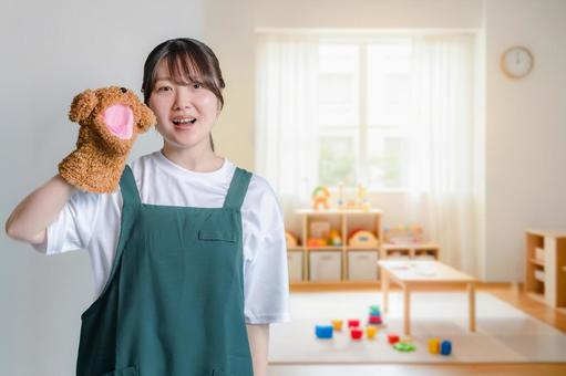 人形とエプロン女性 女性,保育士,幼稚園の写真素材