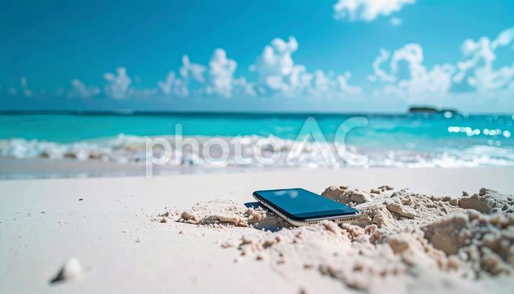 砂浜に置かれたスマートフォン スマートフォン,電話,スマホの写真素材