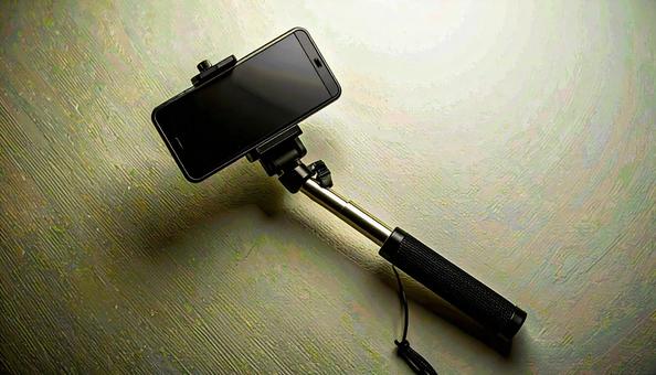 自撮り棒とスマートフォン 自撮り棒とスマートフォンの写真