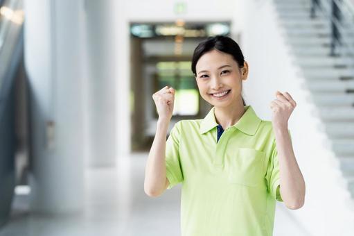介護福祉士の若い女性 介護福祉士の若い女性 ガッツポーズ,介護,介護福祉士の写真素材