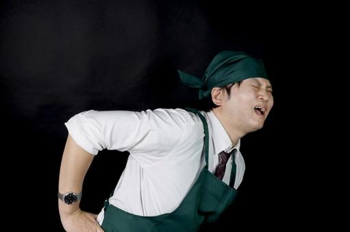 腰を痛めた料理スタッフ 腰を痛めた料理スタッフ 男性,店員,調理スタッフの写真素材