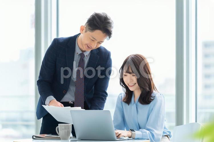 打ち合わせをする男女2人のビジネスマン 男性,女性,男女の写真素材