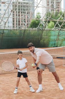 笑顔で指導するスポーツマンと少女 親子,女の子,男性の写真素材