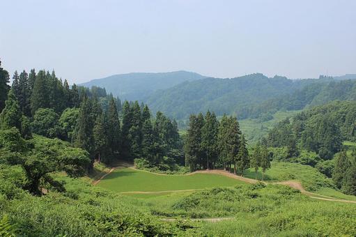 田を守る 田を守る 林,田,山並みの写真素材