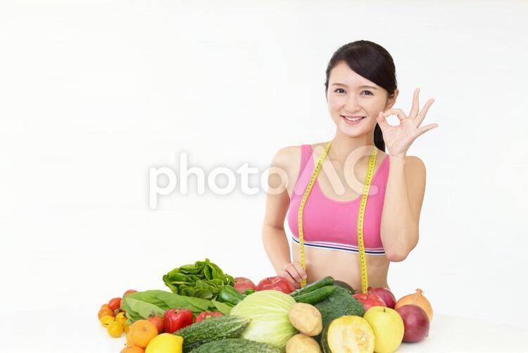 ダイエットに成功した笑顔の女性 女性,野菜,果物の写真素材