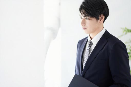 Japanese male businessman looking out the window with a serious expression, wong lanang, pengusaha, refreshing, JPG