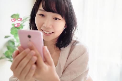A woman who operates a smartphone, JPG A woman who operates a smartphone, female, matching, marriage hunting, JPG