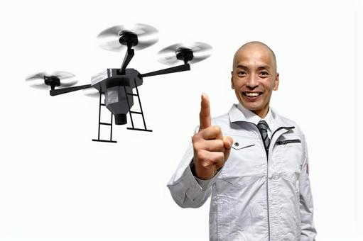 ドローンをおすすめする作業着の中年男性 男性,ビジネス,男の写真素材