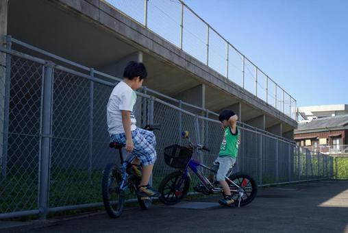 <素材>夜明けの公園で自転車で遊ぶ兄弟 <素材>夜明けの公園で自転車で遊ぶ兄弟 子供,男性,人物の写真素材