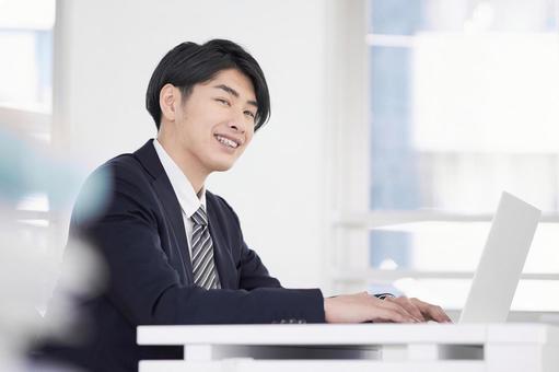 Japanese male businessman working on a laptop with a smile, businessman, a smile, male, JPG