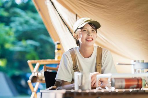 Solo camp image-A young woman relaxing in a tent, camp, solo camp, female, JPG