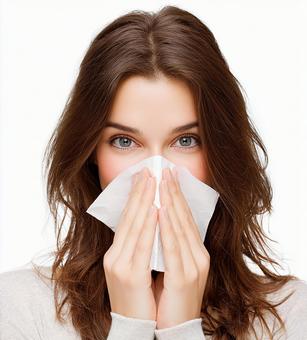 アレルギーに悩む女性の表情の写真