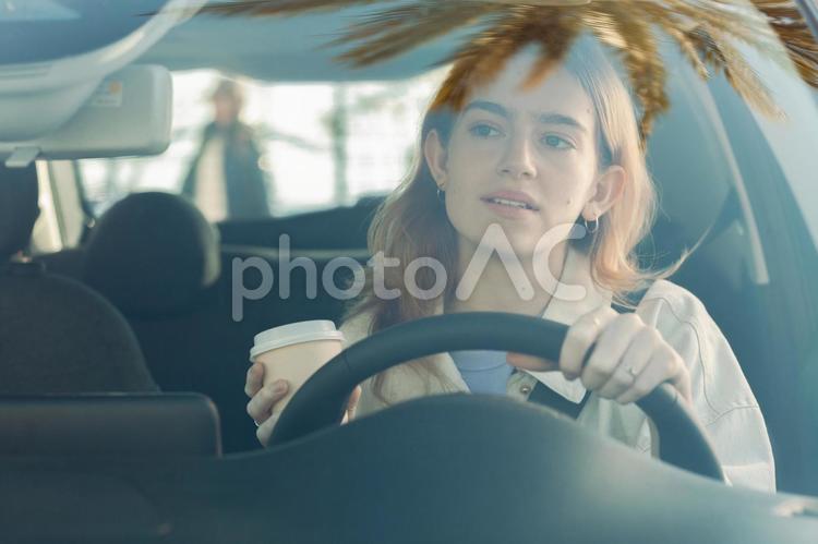 コーヒーを持って運転する女性 女性,電気自動車,コーヒーの写真素材