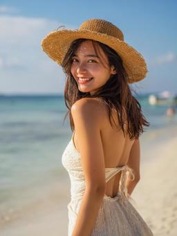 海辺の麦わら帽子を被った女性 海辺の麦わら帽子を被った女性の写真