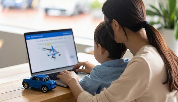A mother working remotely and looking at a computer with her child, computer, screen, child, JPG