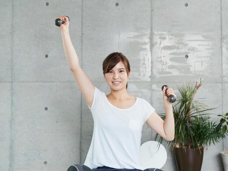 Japanese woman doing dumbbell training at home Japanese woman doing dumbbell training at home